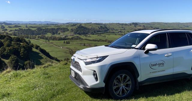image of white B+LNZ branded car parked on farm