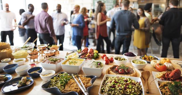 image of buffet food with people in background