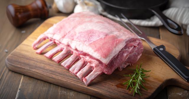 image of fresh lamb rack on cutting board next to knife