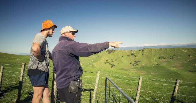 image of two farmers looking at land