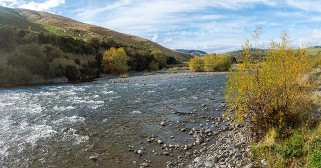 image of river running through farm and autumn colours