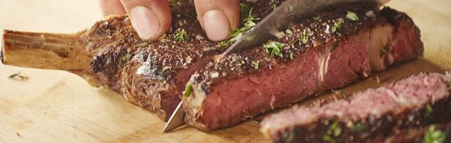 red meat being cut image of person cutting red meat