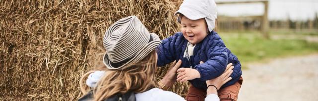 open farms image of toddler and mother on-farm